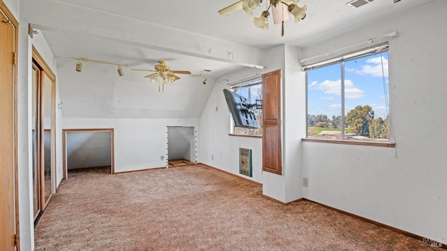 bonus room with vaulted ceiling, a ceiling fan, baseboards, and carpet floors