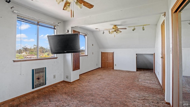 unfurnished living room with baseboards, ceiling fan, vaulted ceiling, carpet floors, and heating unit