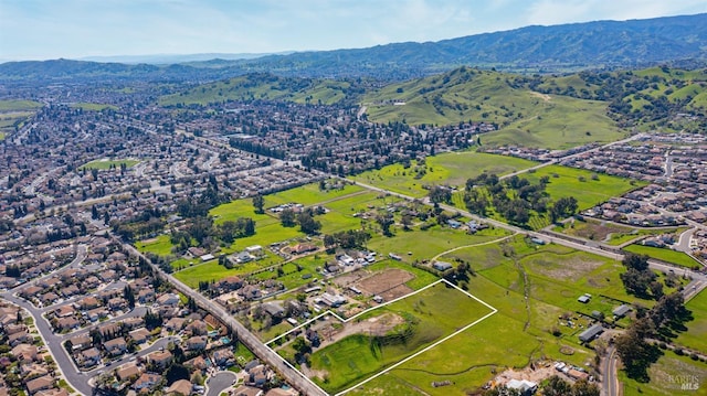 birds eye view of property with a mountain view