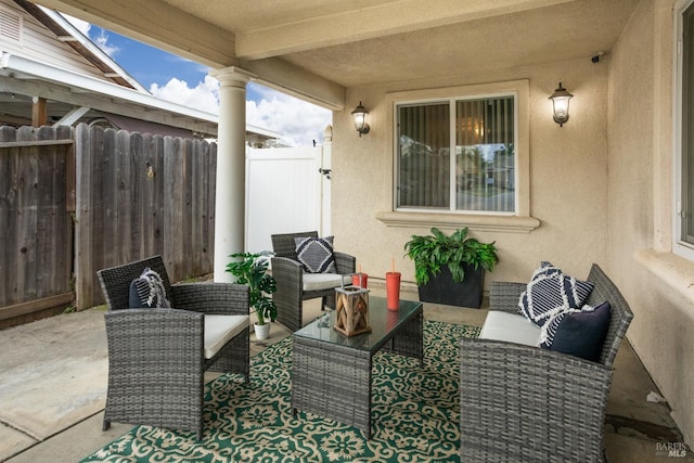 view of patio with outdoor lounge area and fence