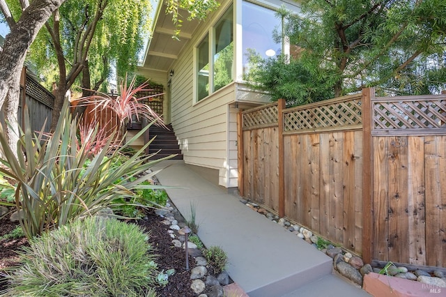 view of side of property featuring fence