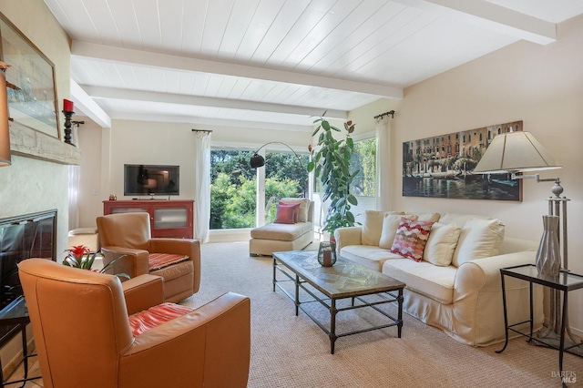 living area featuring wooden ceiling, carpet flooring, a glass covered fireplace, and beam ceiling