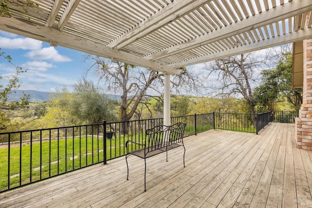 deck featuring a lawn and a pergola