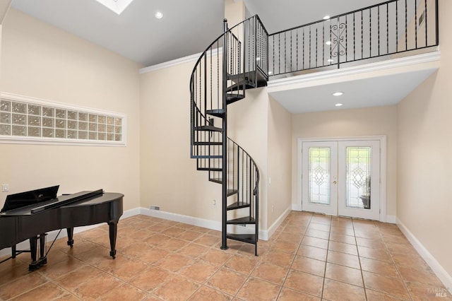 tiled foyer entrance with french doors, a high ceiling, baseboards, and stairs