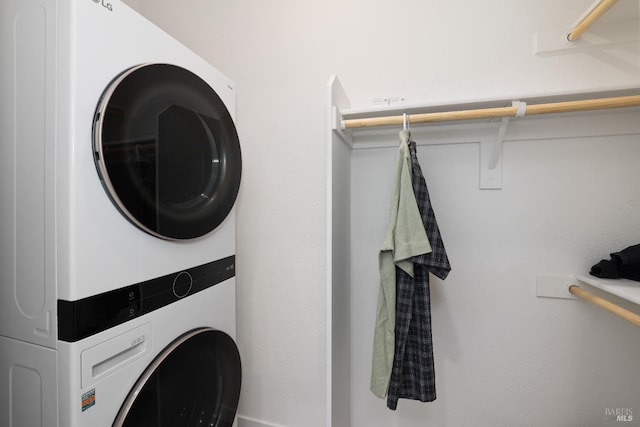 clothes washing area featuring laundry area and stacked washer / dryer