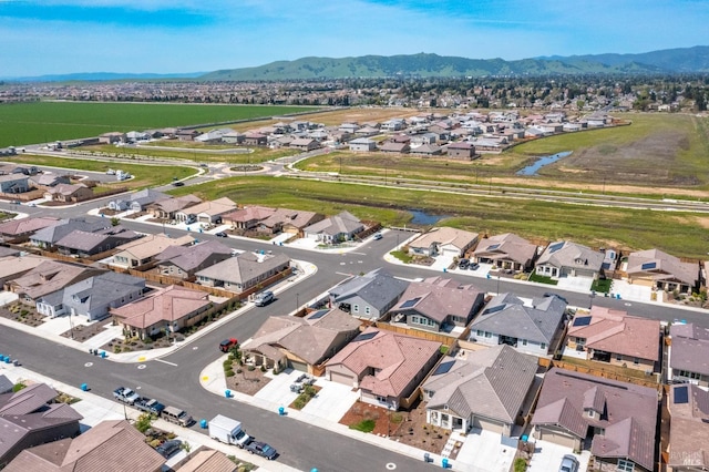 birds eye view of property with a mountain view and a residential view