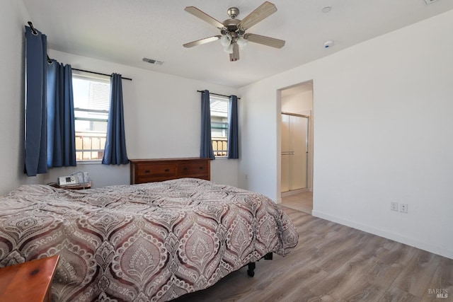 bedroom featuring visible vents, light wood-style flooring, baseboards, and ceiling fan