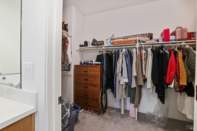 walk in closet with carpet