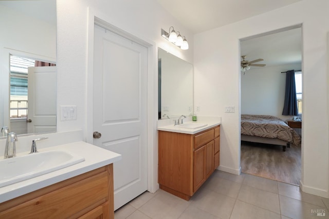 bathroom featuring tile patterned floors, a wealth of natural light, and a sink