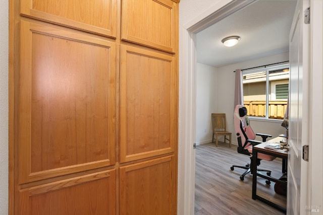 office space with baseboards and wood finished floors