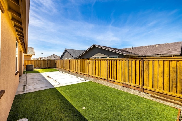 view of yard featuring central AC, a patio area, and a fenced backyard