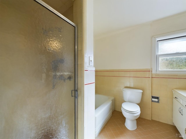 full bathroom with a shower stall, a washtub, wainscoting, tile patterned floors, and tile walls