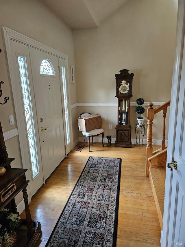 foyer with stairs and wood finished floors