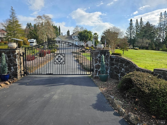 view of gate featuring a yard