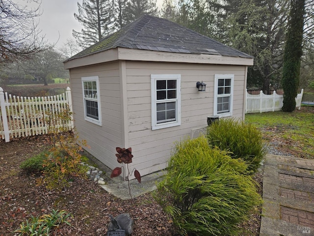 view of outbuilding featuring an outbuilding and fence