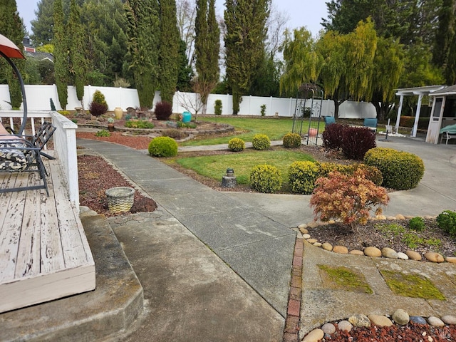 view of property's community featuring a fenced backyard, a yard, and a patio area