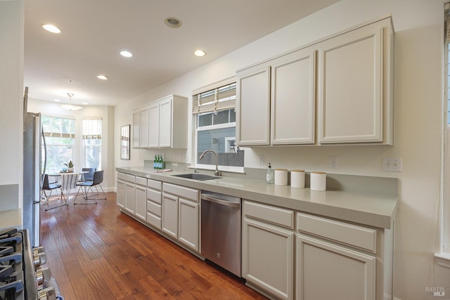 kitchen with light countertops, recessed lighting, appliances with stainless steel finishes, dark wood-style floors, and a sink