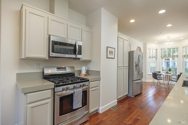 kitchen featuring visible vents, dark wood finished floors, recessed lighting, appliances with stainless steel finishes, and light countertops