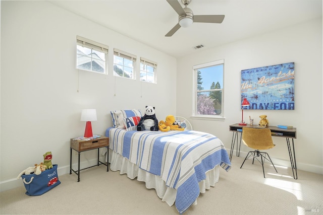 carpeted bedroom featuring visible vents, a ceiling fan, and baseboards