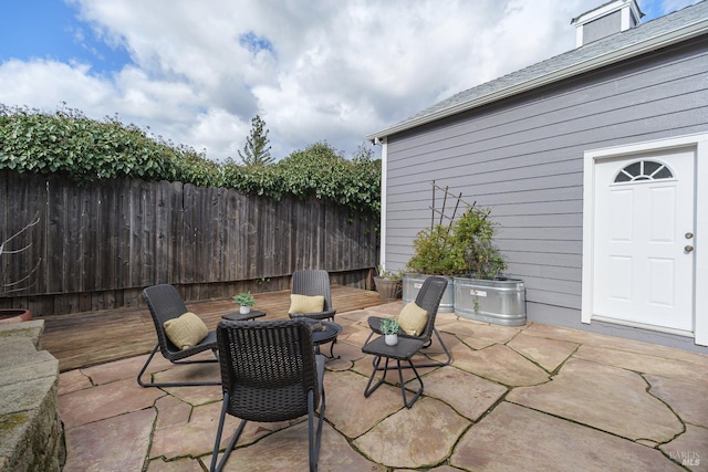 view of patio featuring fence