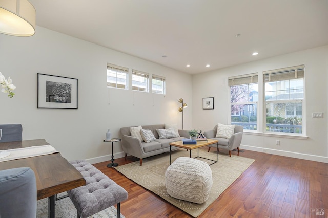 living room featuring recessed lighting, baseboards, and wood finished floors