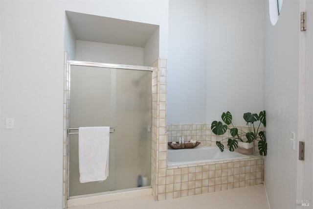 full bathroom featuring a bath and a stall shower