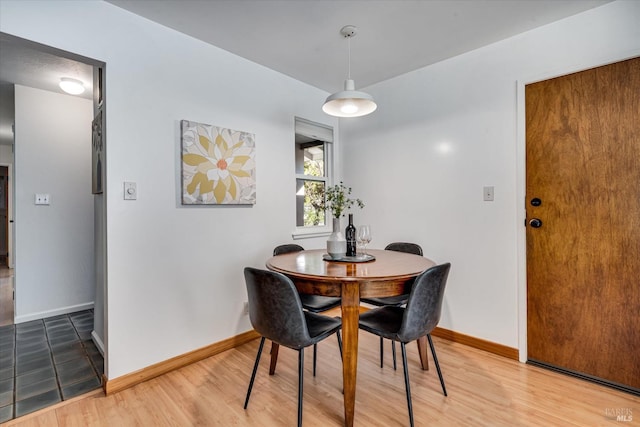 dining area featuring baseboards and wood finished floors