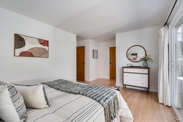 bedroom featuring light wood-type flooring and baseboards