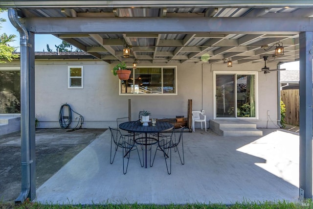 view of patio / terrace with entry steps, fence, and outdoor dining space