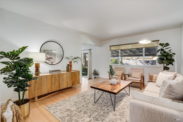 living room featuring light wood finished floors and baseboards