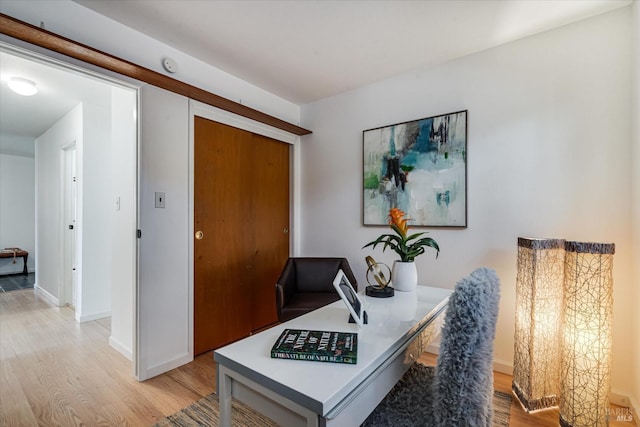 office with light wood-style floors and baseboards