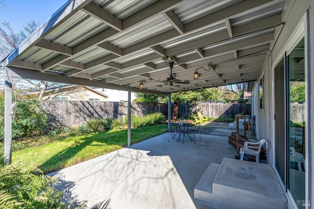 view of patio / terrace with ceiling fan, a fenced backyard, and outdoor dining area