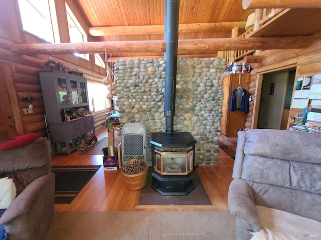 living room with a wood stove, wooden ceiling, and wood finished floors