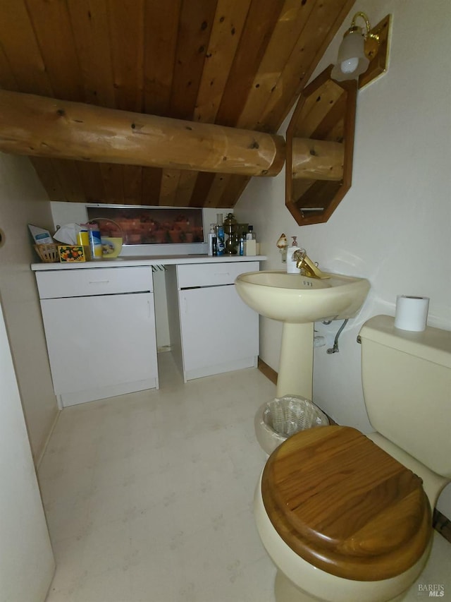 half bath featuring toilet, wooden ceiling, lofted ceiling with beams, and tile patterned floors