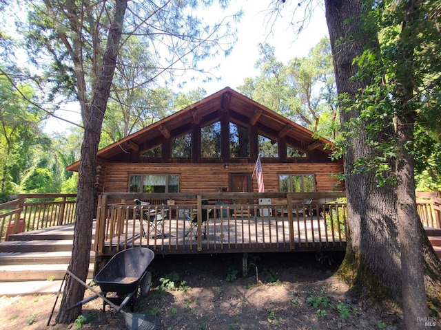 rear view of property featuring a deck