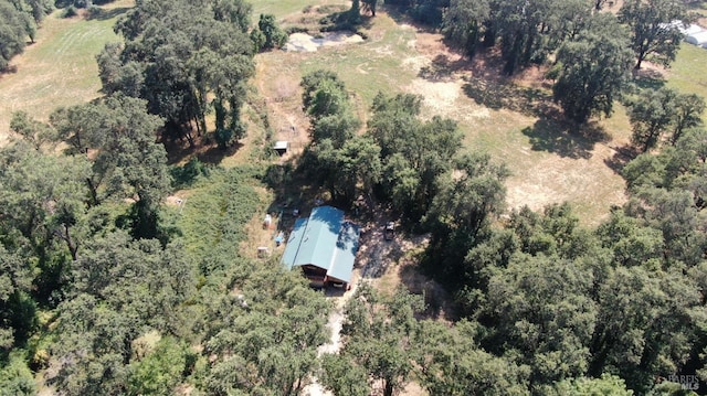 birds eye view of property with a wooded view