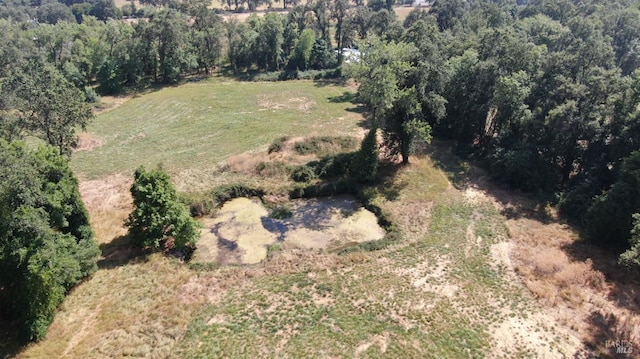 drone / aerial view featuring a forest view