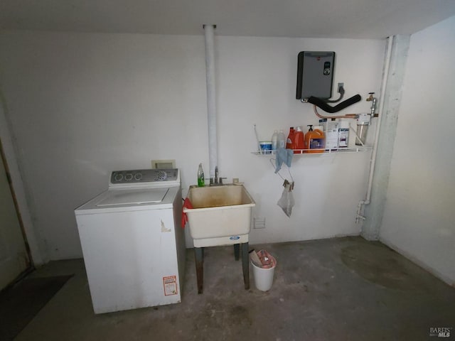 washroom with washer / dryer and a sink