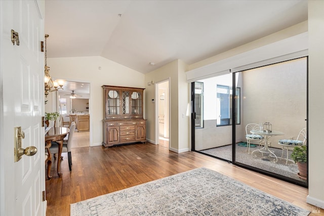 foyer featuring a healthy amount of sunlight, vaulted ceiling, and wood finished floors