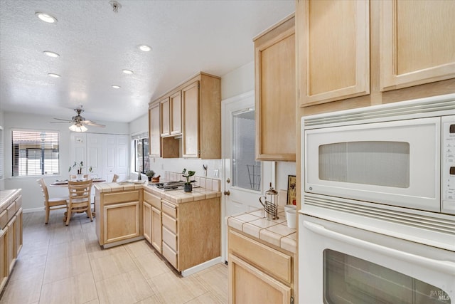 kitchen featuring tile countertops and light brown cabinetry