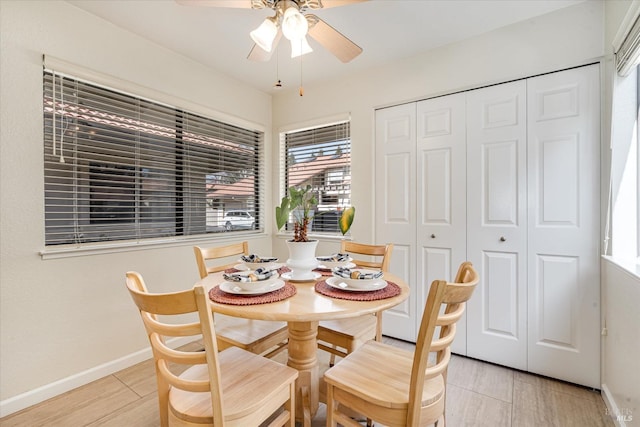 dining area with ceiling fan and baseboards