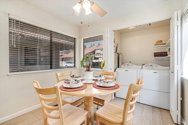 dining room featuring baseboards, a ceiling fan, and washing machine and clothes dryer