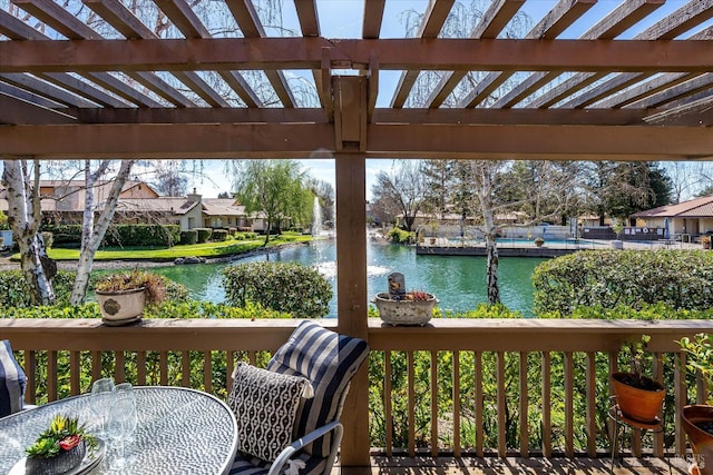 wooden deck with a water view, a residential view, and outdoor dining area