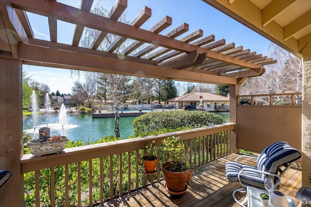 deck featuring a water view and a pergola