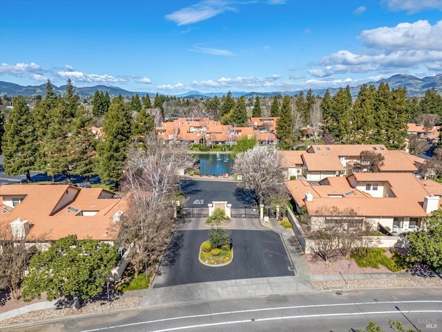 bird's eye view with a water and mountain view and a residential view