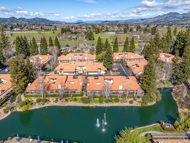 birds eye view of property featuring a residential view and a water and mountain view