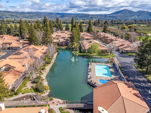 drone / aerial view with a water and mountain view