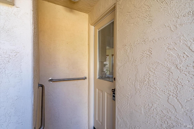 entrance to property featuring stucco siding