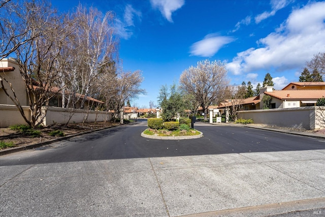 view of street featuring a residential view and curbs