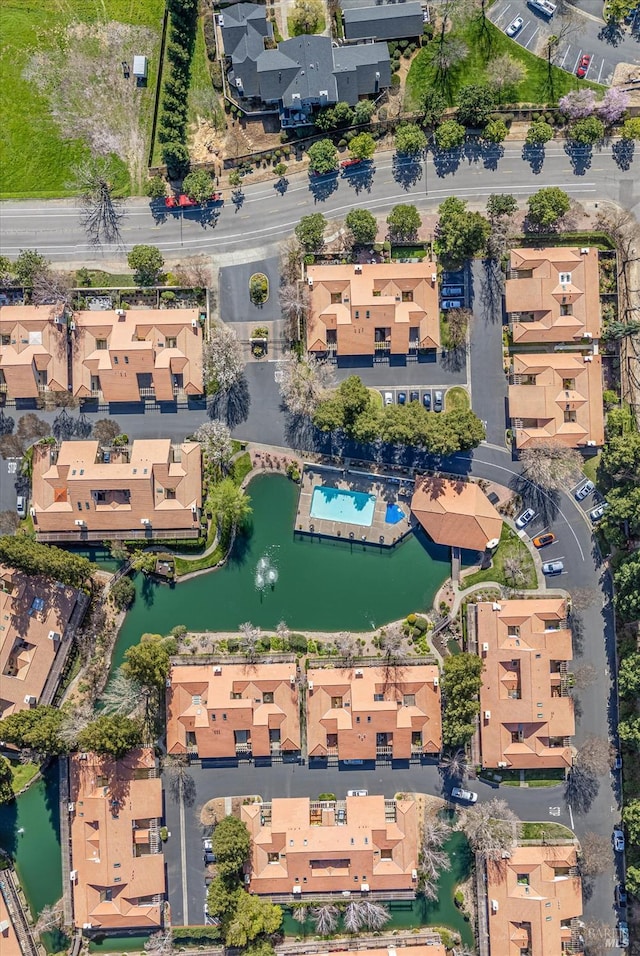 drone / aerial view with a residential view and a water view